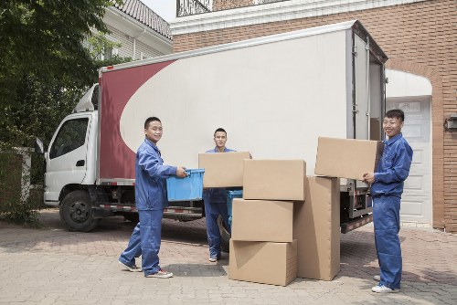Students moving boxes and furniture in a Chiswick street